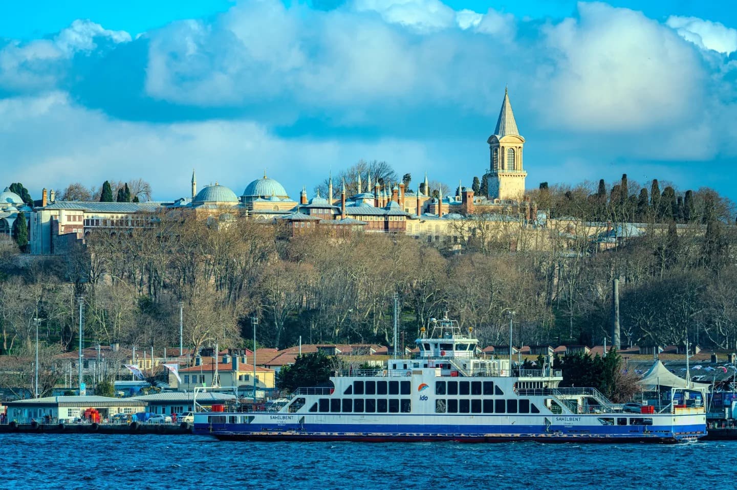 Across the Water. The sea separates facade and city in an open composition.