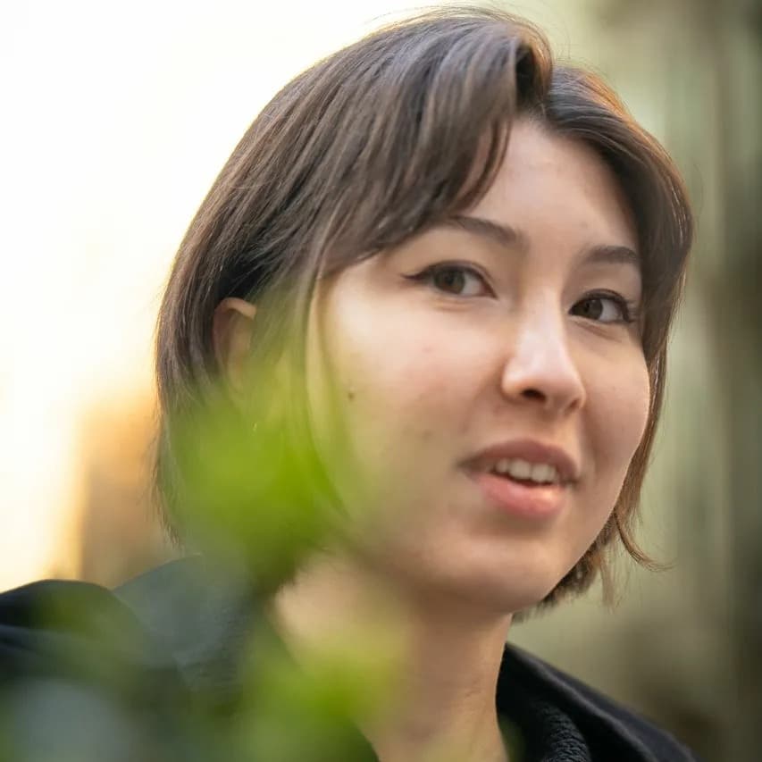Glance Through Leaves. A face emerging through leaves with a calm, direct tone.