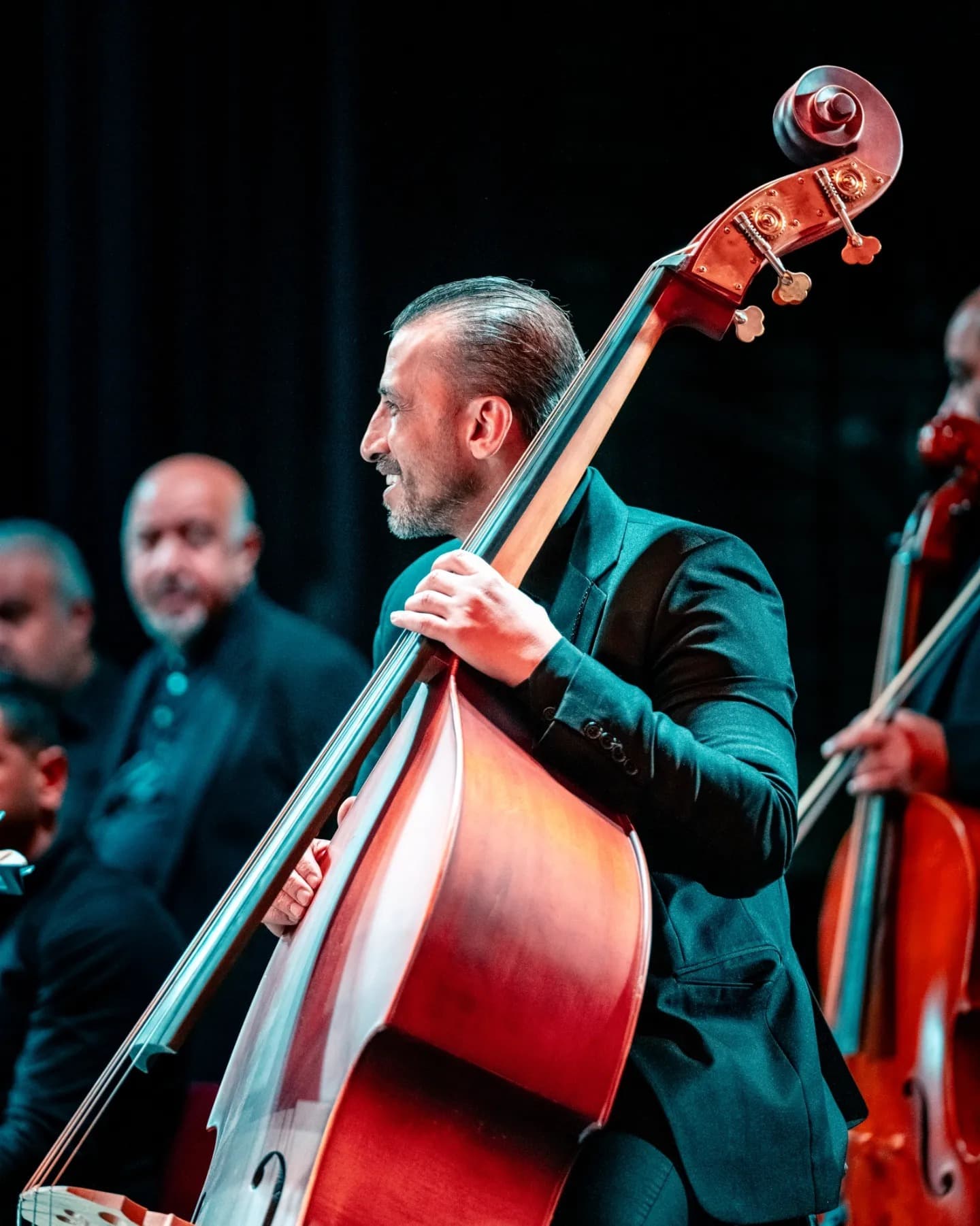 Double Bass Solo. The bassist and stage condense a moment of focused listening.