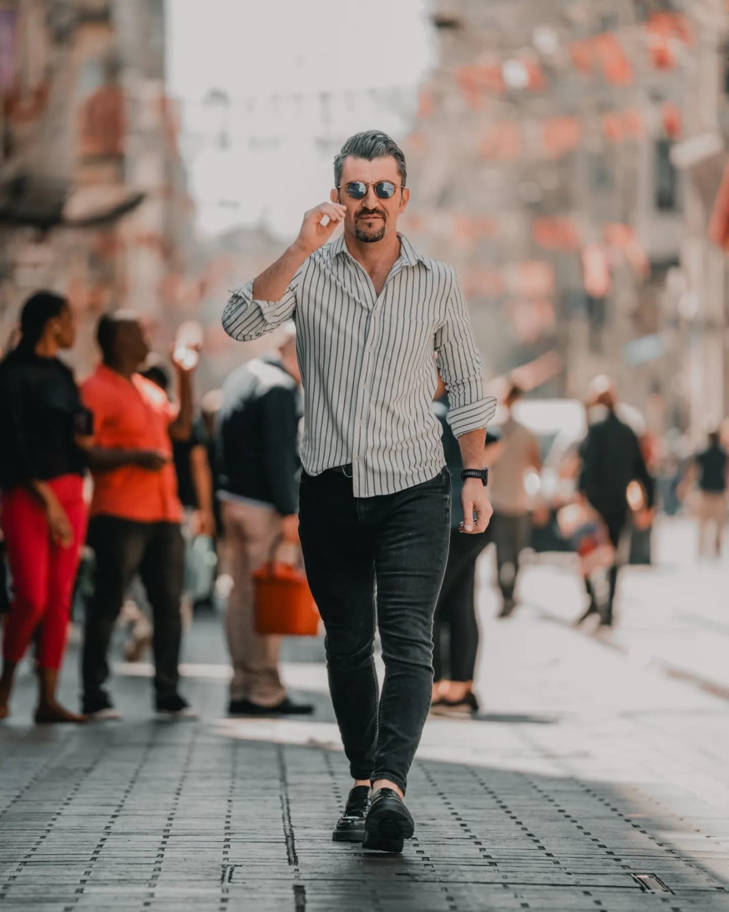 Pedestrian in Grey. Muted color and posture make the scene feel human rather than performative.