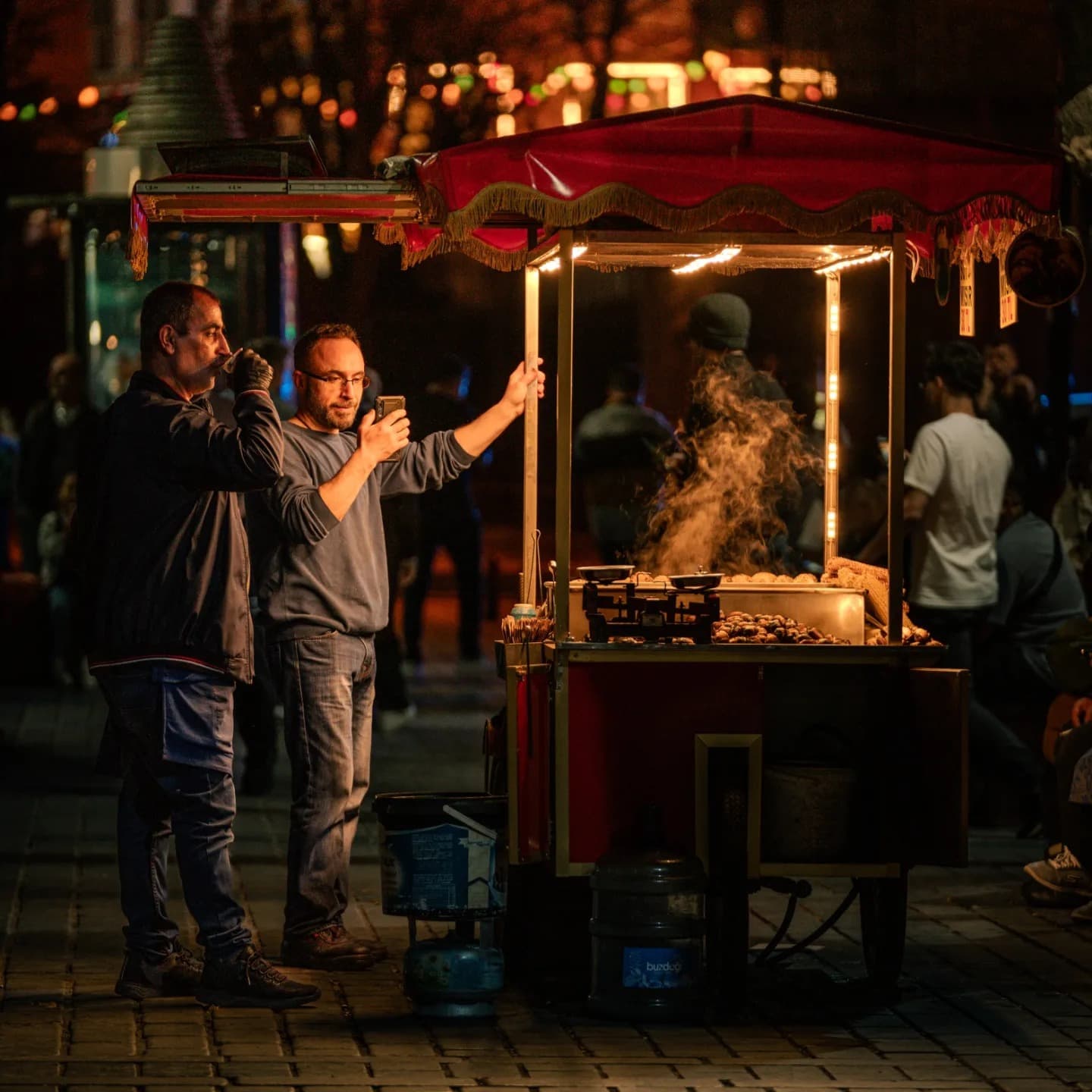 Lantern Stall. Popular simplicity appears in a small cart lit by color.