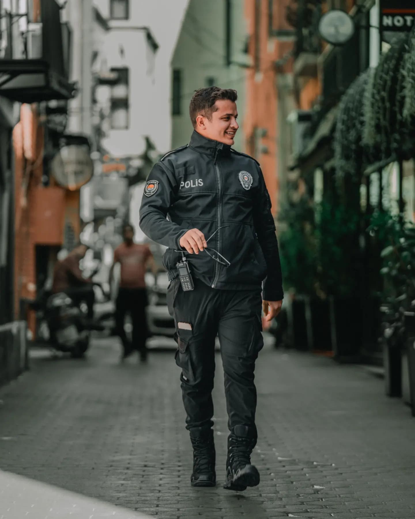 Urban Watch. His steady stance gives the public space a human anchor.