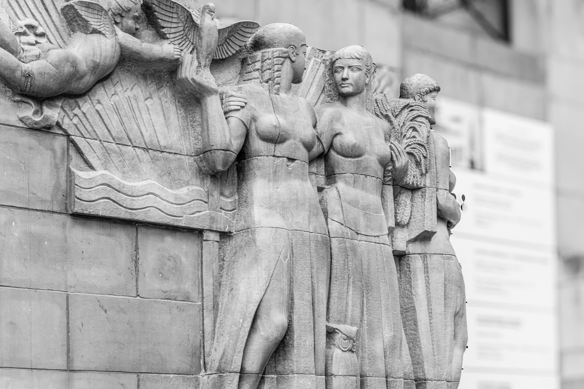 Figures in Stone. The sculpted figures appear as silent guardians of the upper facade.