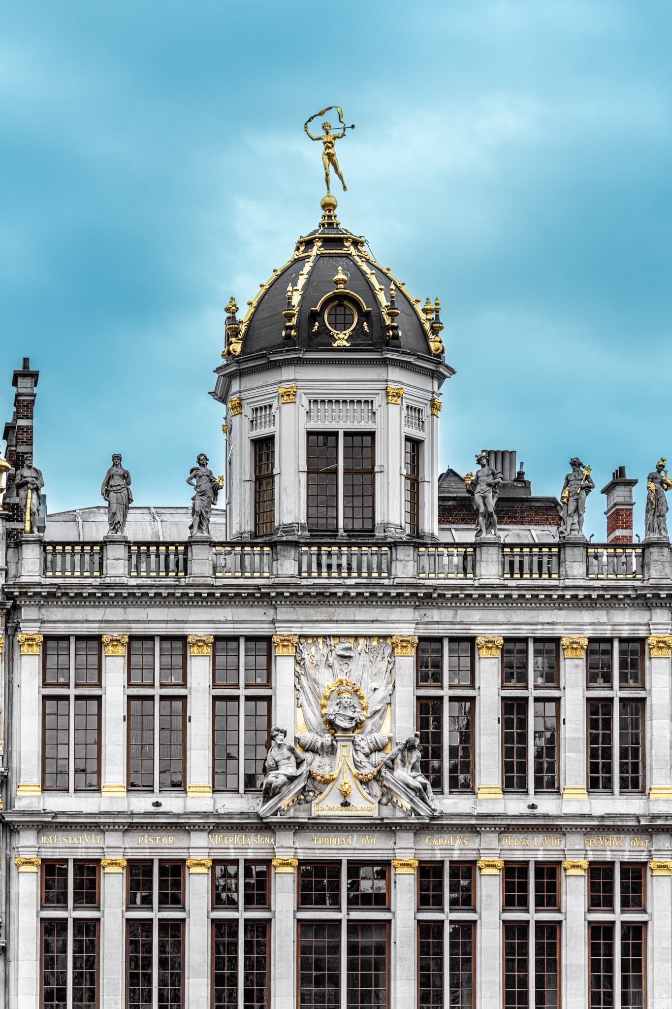 Crowned Rooftop. The roofline becomes a rhythm of crowns and ornaments.