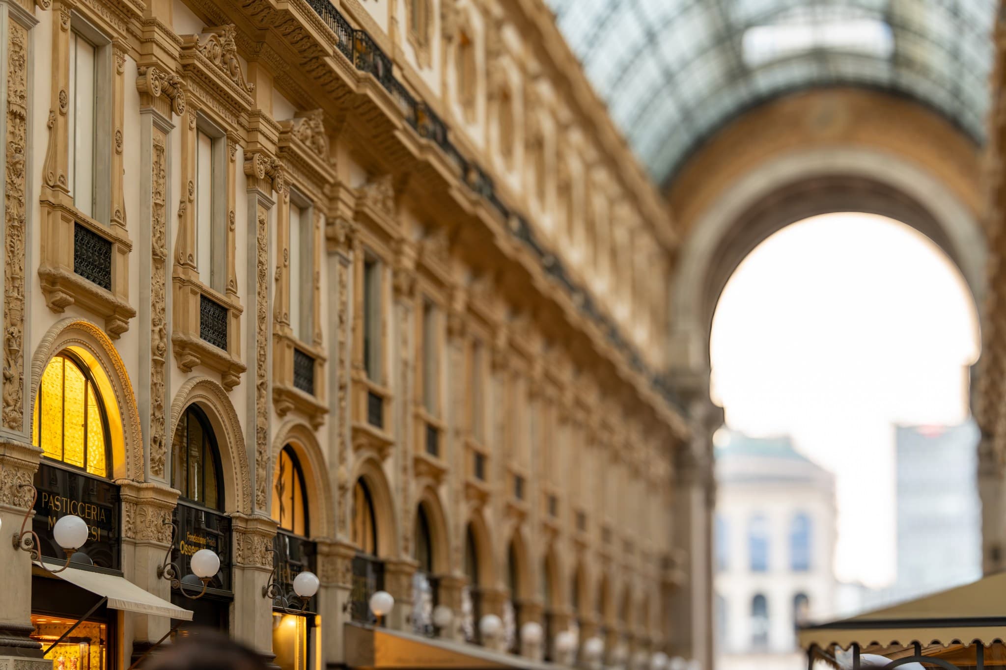 Galleria Arch. A broad arch guides the eye between interior space and passing movement.